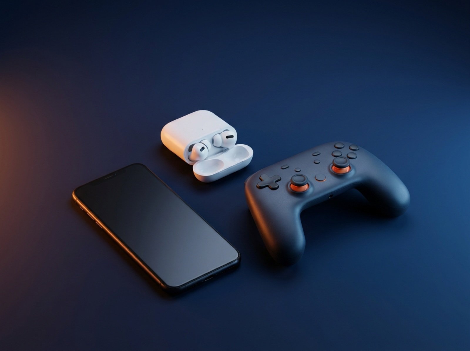 Smartphone, wireless earbuds and a game controller held in stock